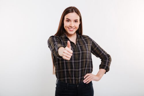 smiling woman shirt showing thumb up